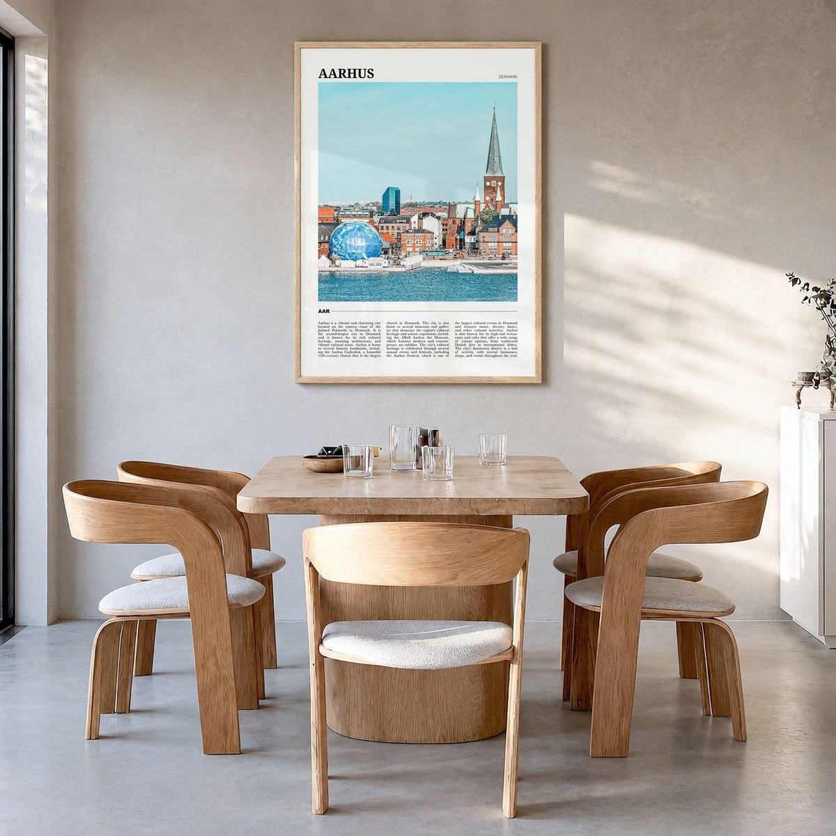 Aarhus Travel Poster in a natural wood frame, hanging in a dining room