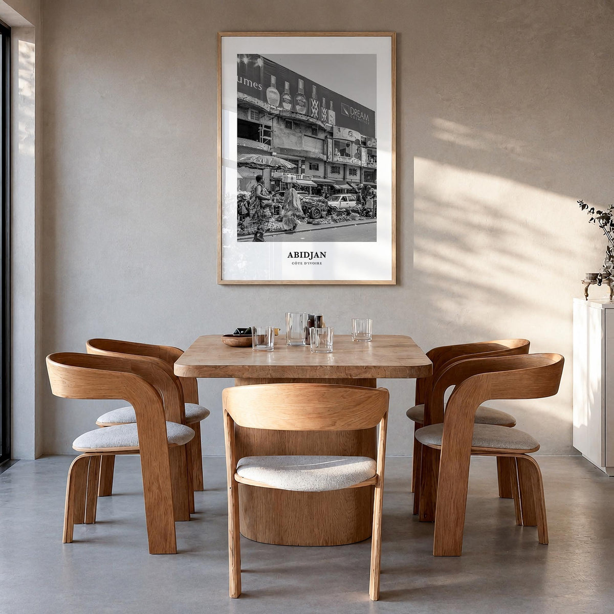 Abidjan black & white classic poster of Côte d'Ivoire – vertical wall art in natural wood frame, hanging on wall