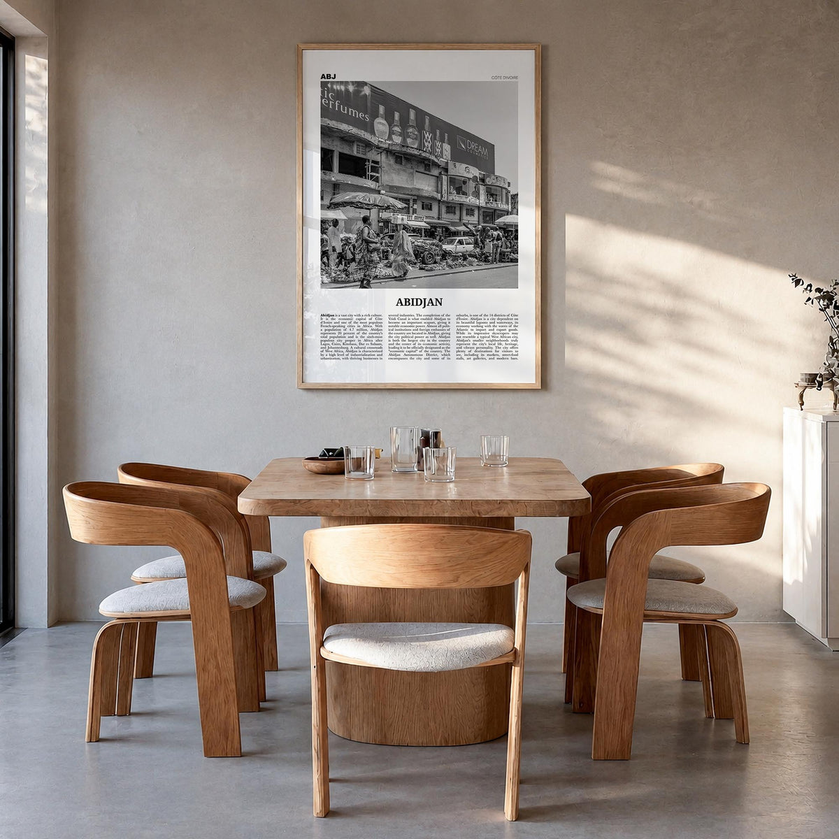 Abidjan black & white newspaper poster of Côte d'Ivoire – vertical wall art in natural wood frame, hanging on wall