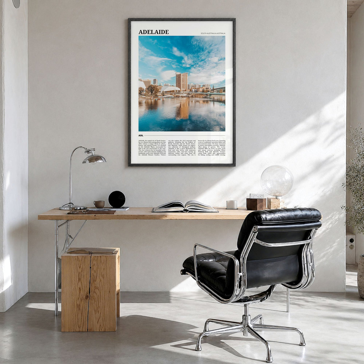 Adelaide Travel Poster in a black wood frame, hanging in a bright home office
