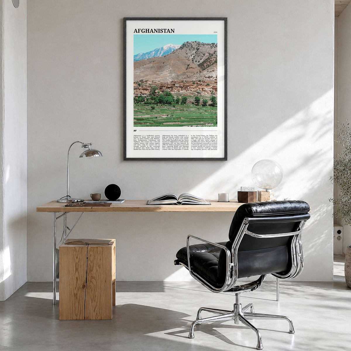Afghanistan Travel Poster in a black wood frame, hanging in a bright home office