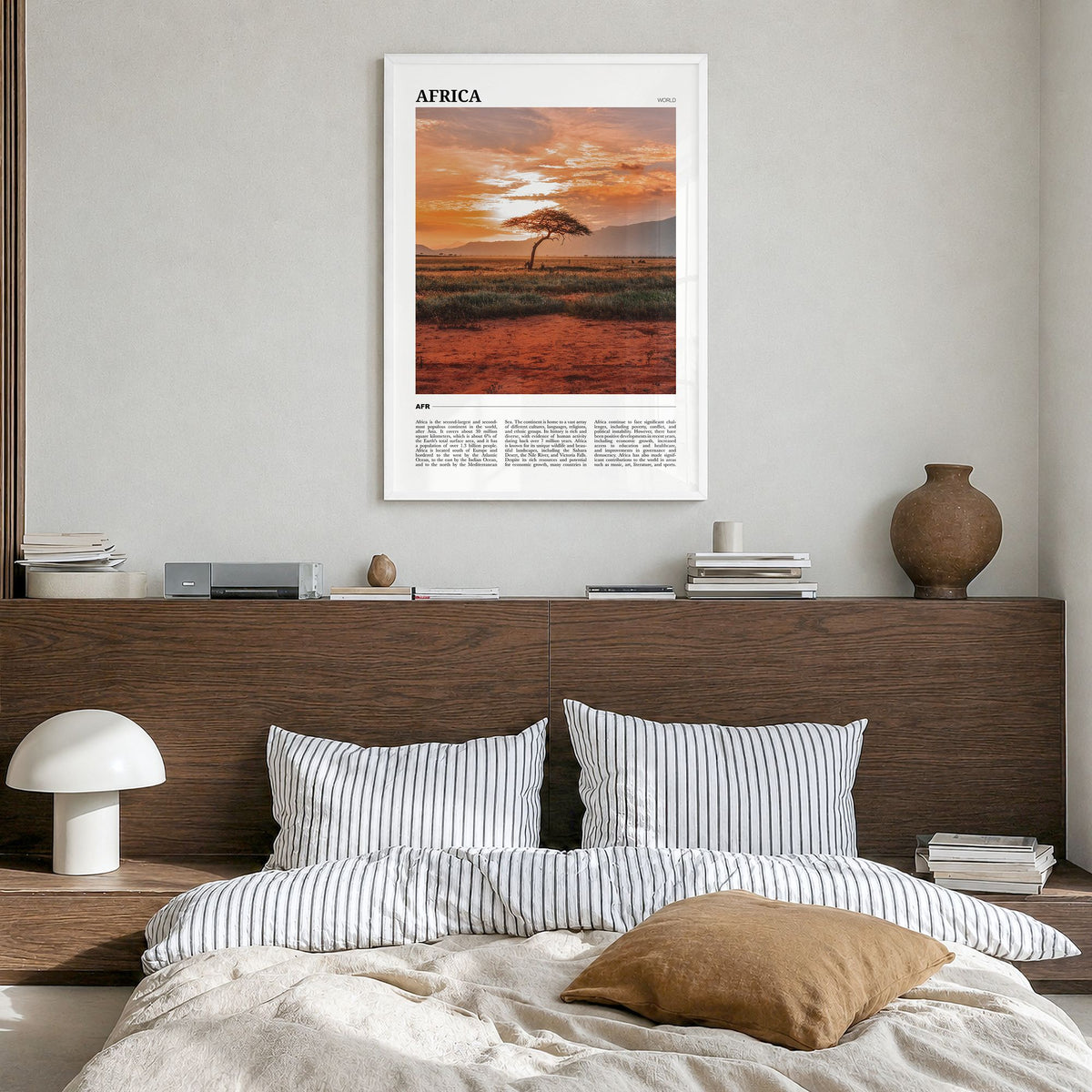 Africa Travel Poster in a white wood frame, hanging in a bedroom