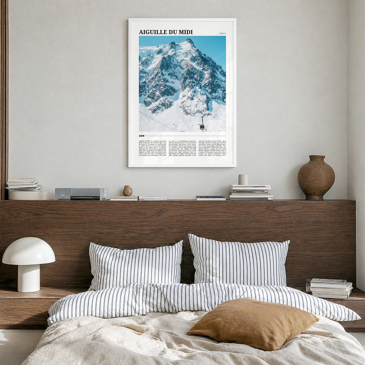 Aiguille du Midi Travel Poster in a white wood frame, hanging in a bedroom