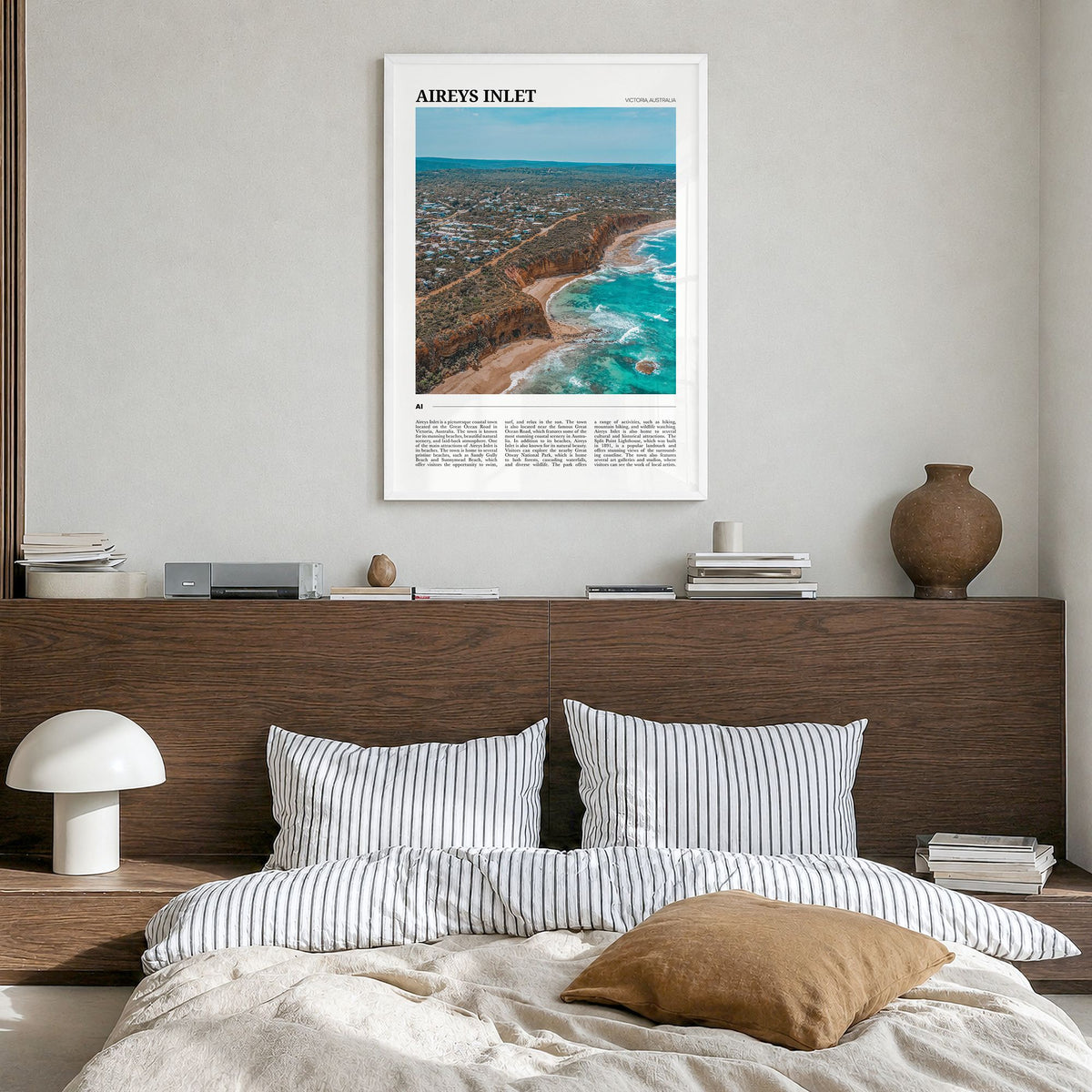 Aireys Inlet Travel Poster in a white wood frame, hanging in a bedroom