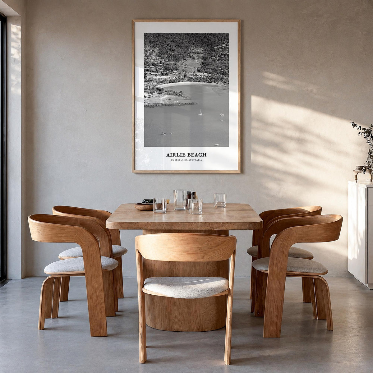 Airlie Beach black & white classic poster of Queensland, Australia – vertical wall art in natural wood frame, hanging on wall