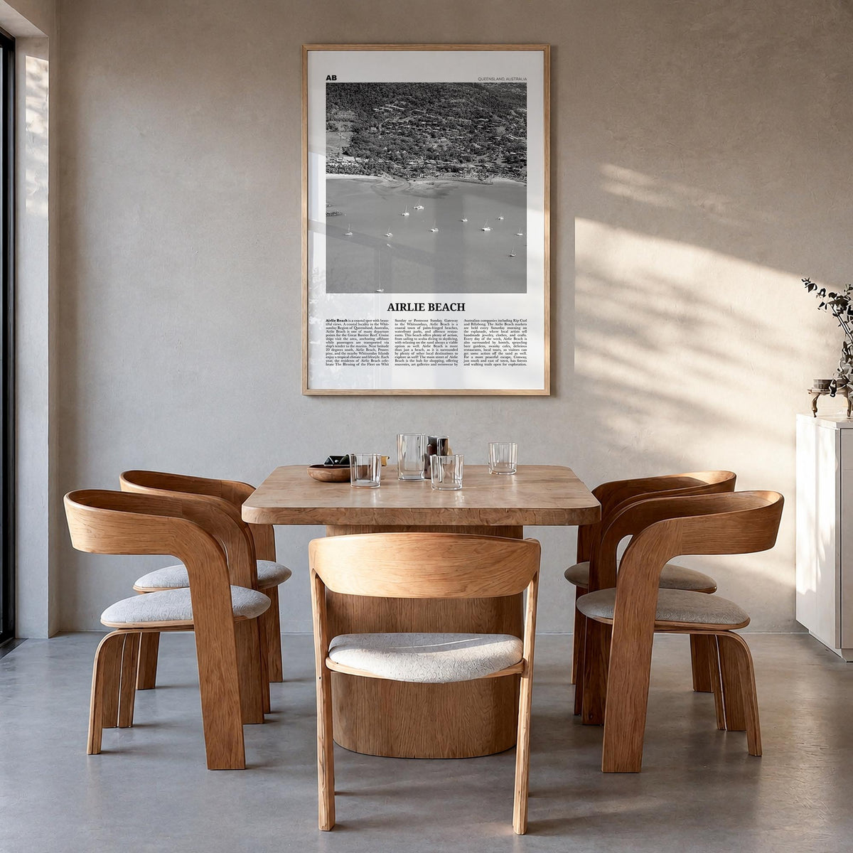 Airlie Beach black & white newspaper poster of Queensland, Australia – vertical wall art in natural wood frame, hanging on wa