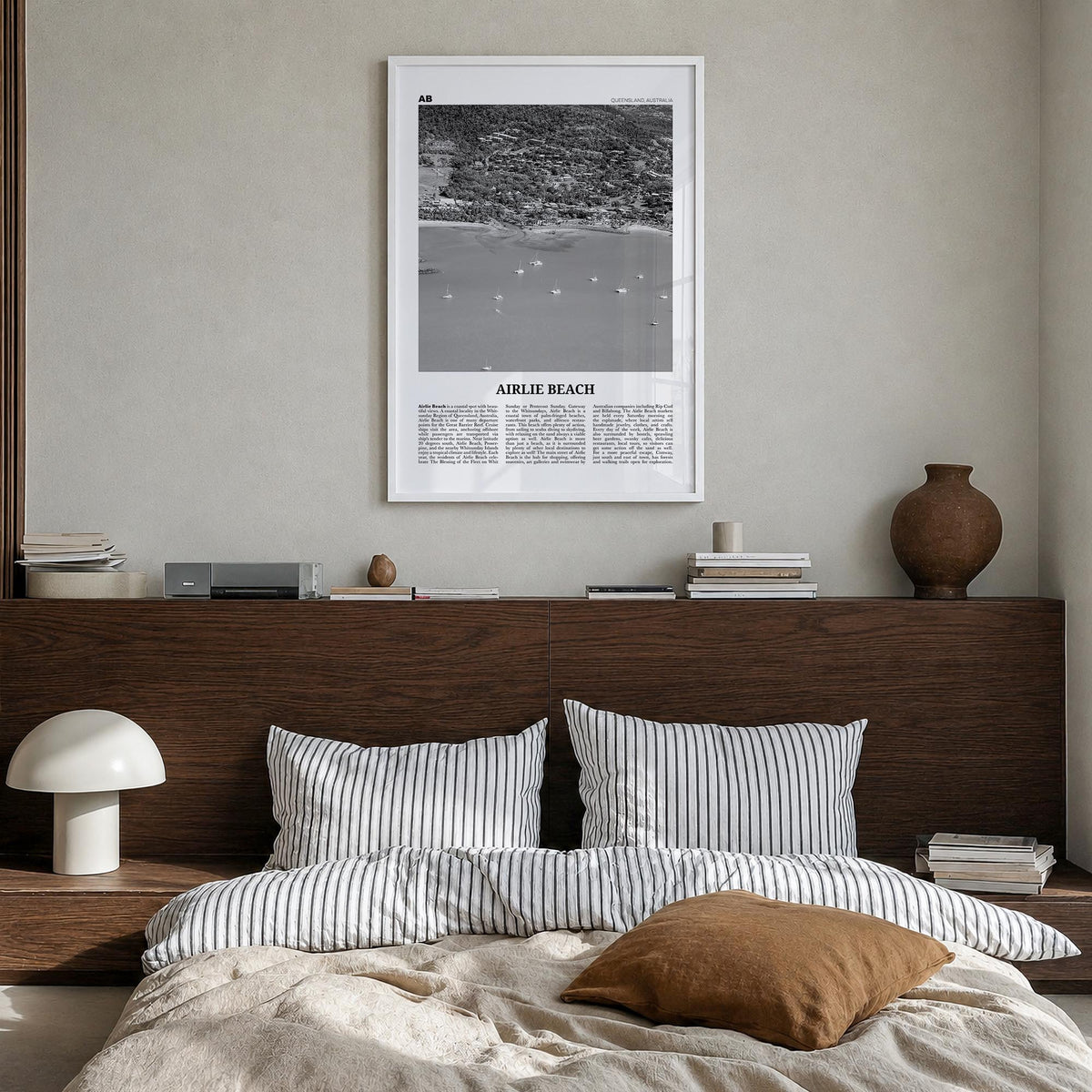 Airlie Beach black & white newspaper poster of Queensland, Australia – vertical wall art in white wood frame, hanging on wall