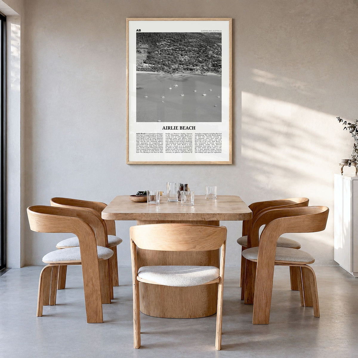 Airlie Beach Newspaper Poster in a natural wood frame, hanging in a dining room