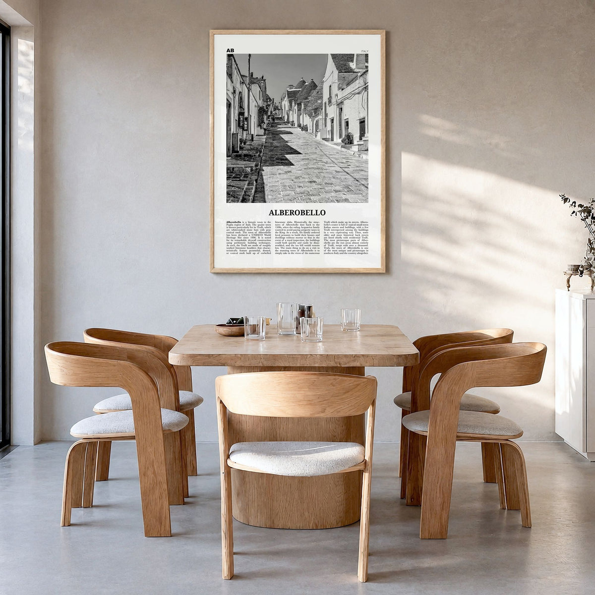 Alberobello Newspaper Poster in a natural wood frame, hanging in a dining room
