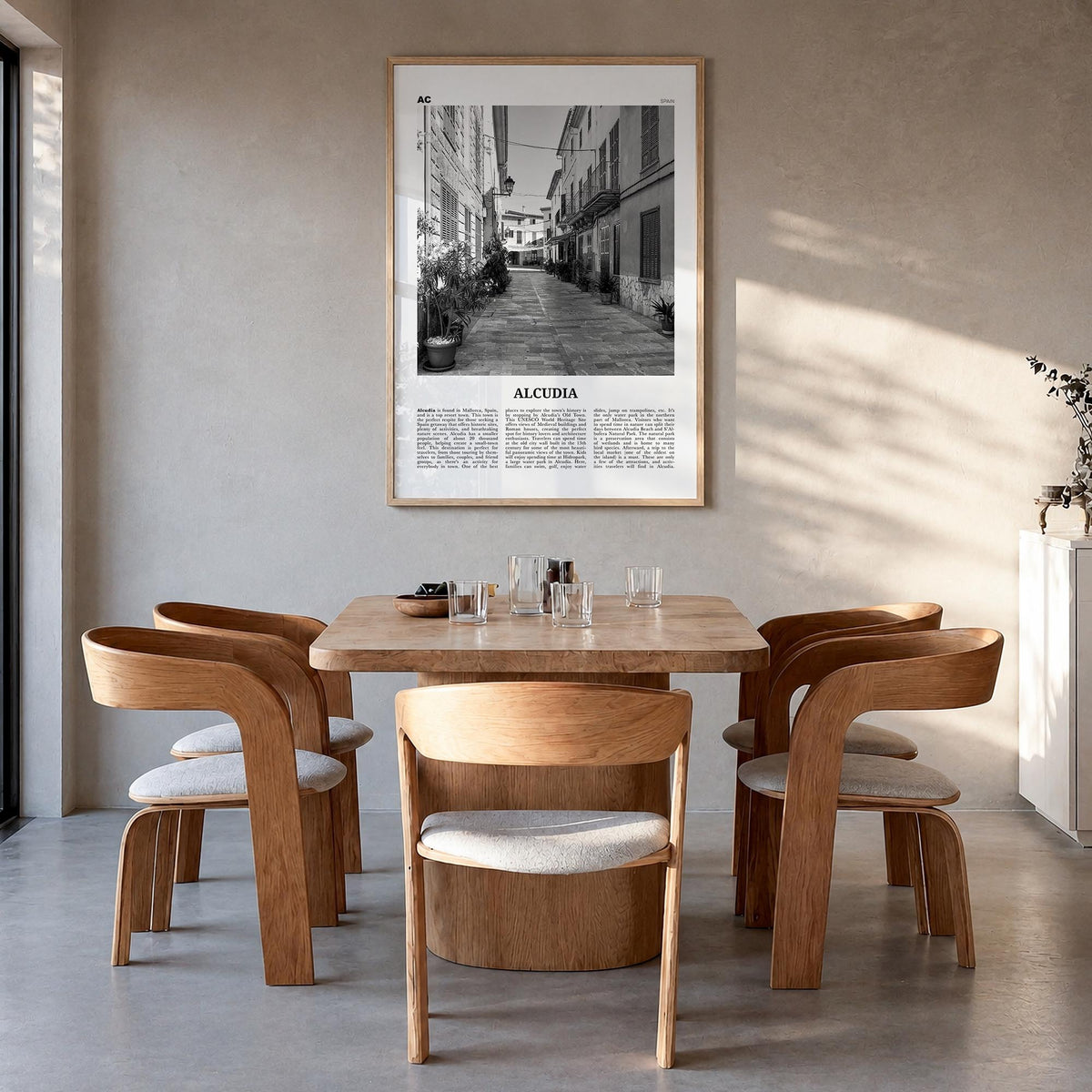 Alcudia black & white newspaper poster of Spain – vertical wall art in natural wood frame, hanging on wall