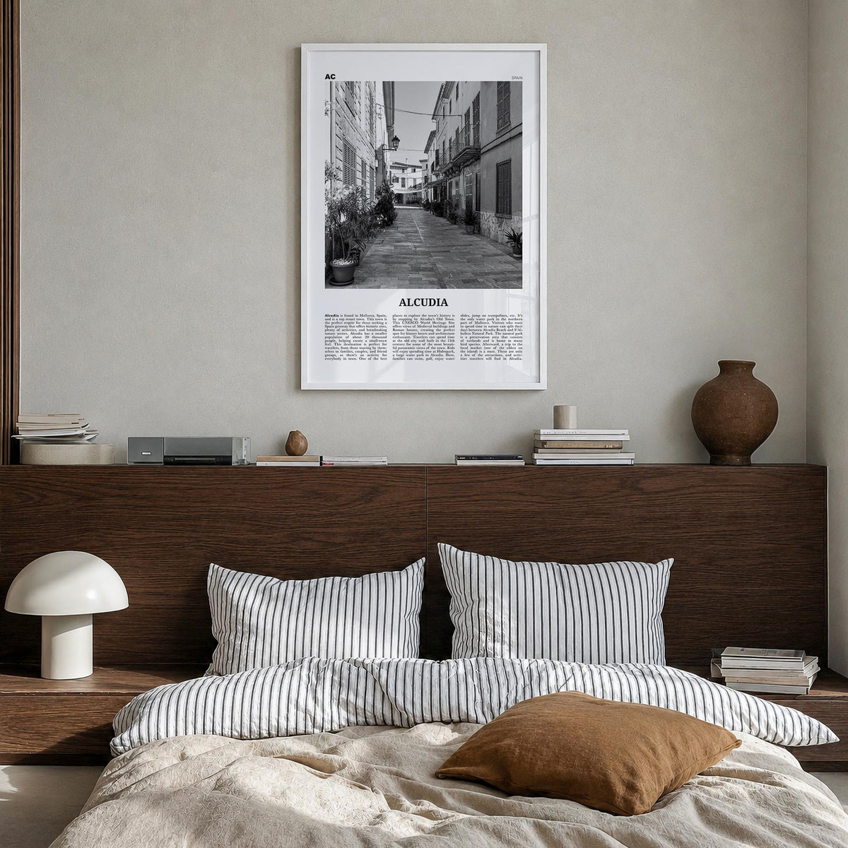Alcudia black & white newspaper poster of Spain – vertical wall art in white wood frame, hanging on wall