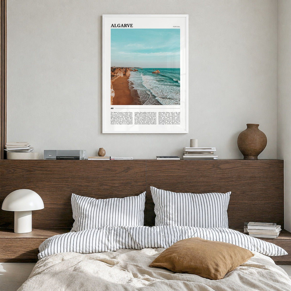 Algarve Travel Poster in a white wood frame, hanging in a bedroom