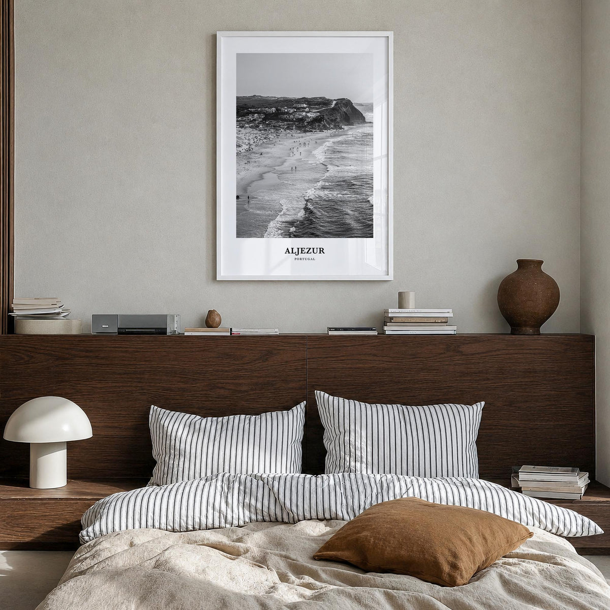 Aljezur black & white classic poster of Portugal – vertical wall art in white wood frame, hanging on wall