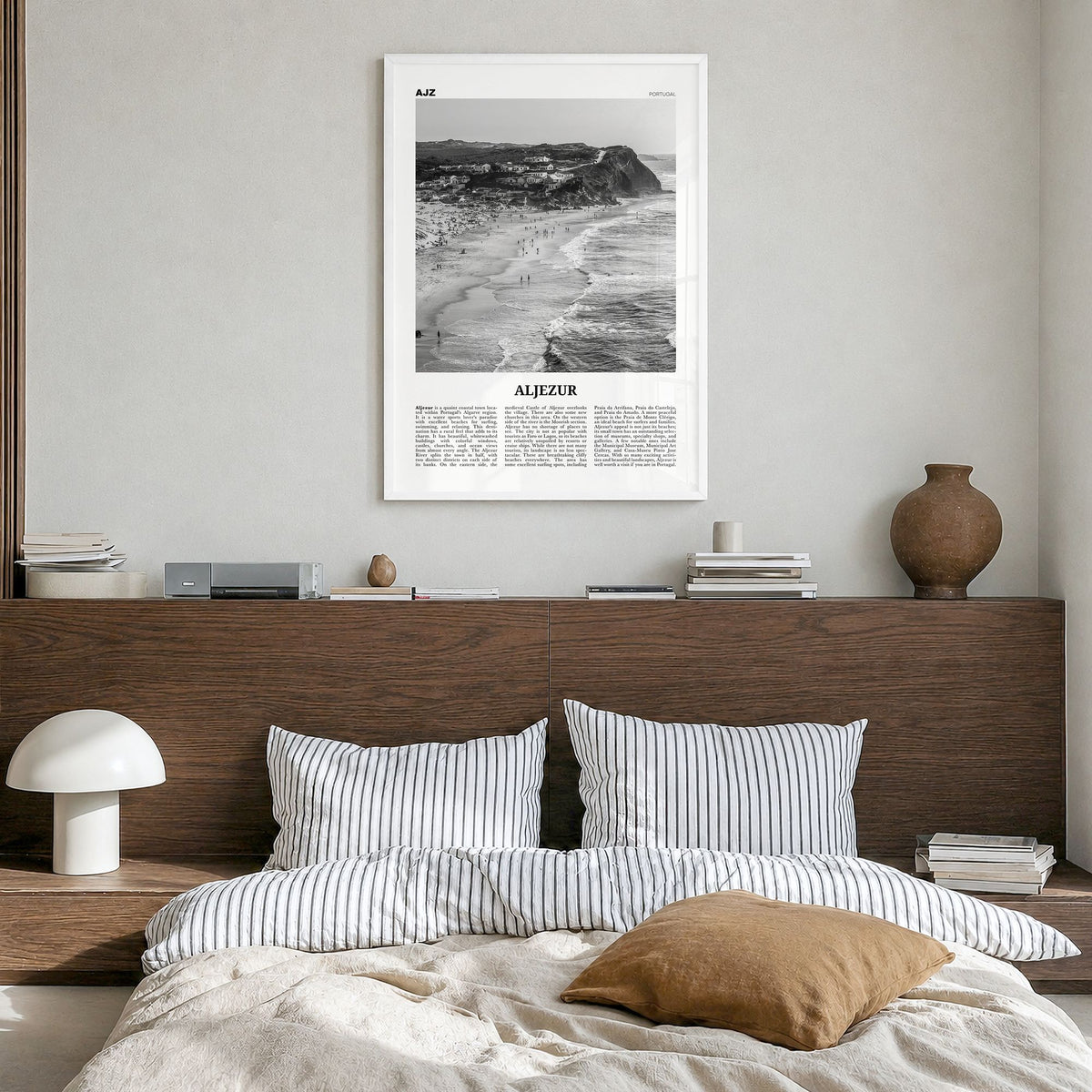 Aljezur Newspaper Poster in a white wood frame, hanging in a bedroom