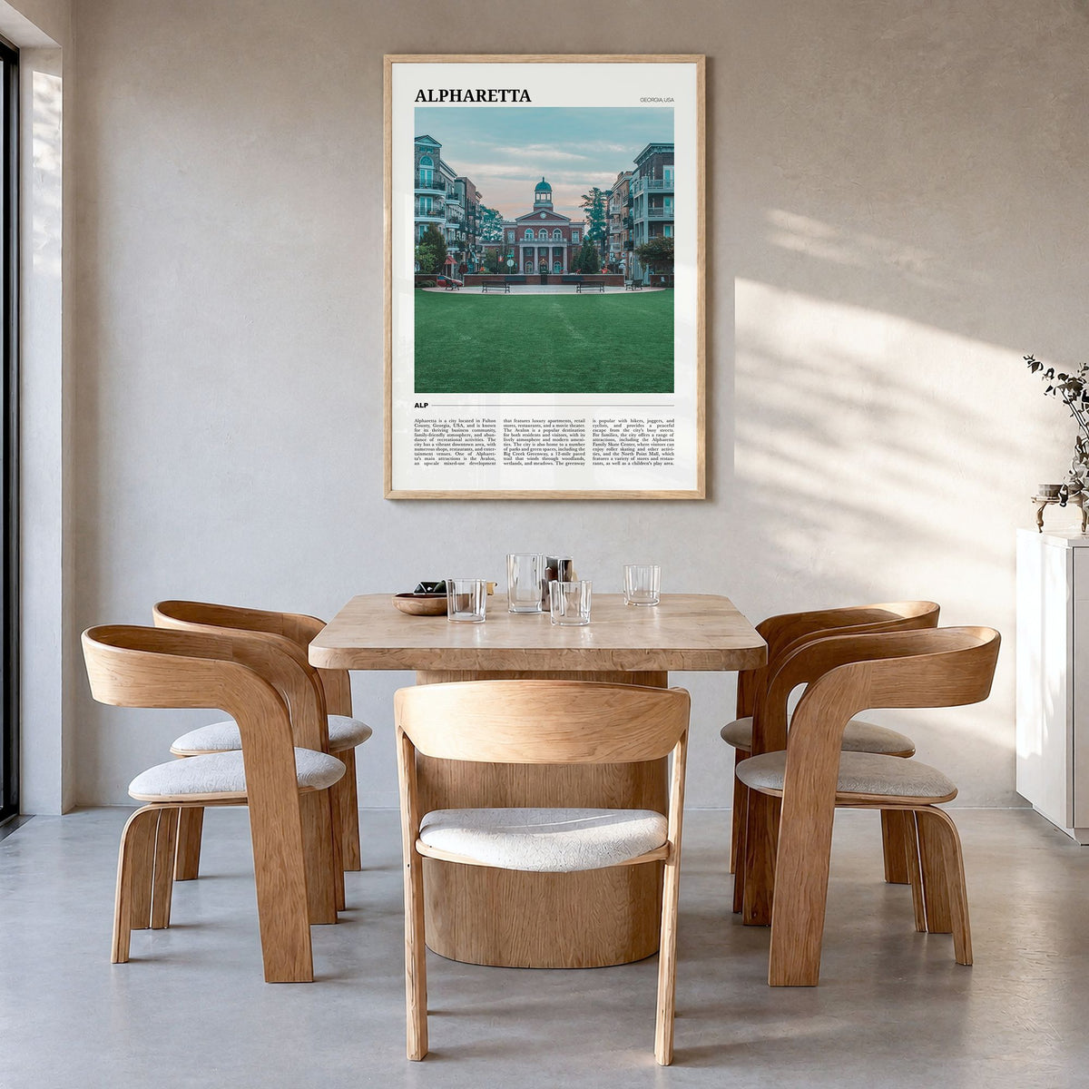 Alpharetta Travel Poster in a natural wood frame, hanging in a dining room