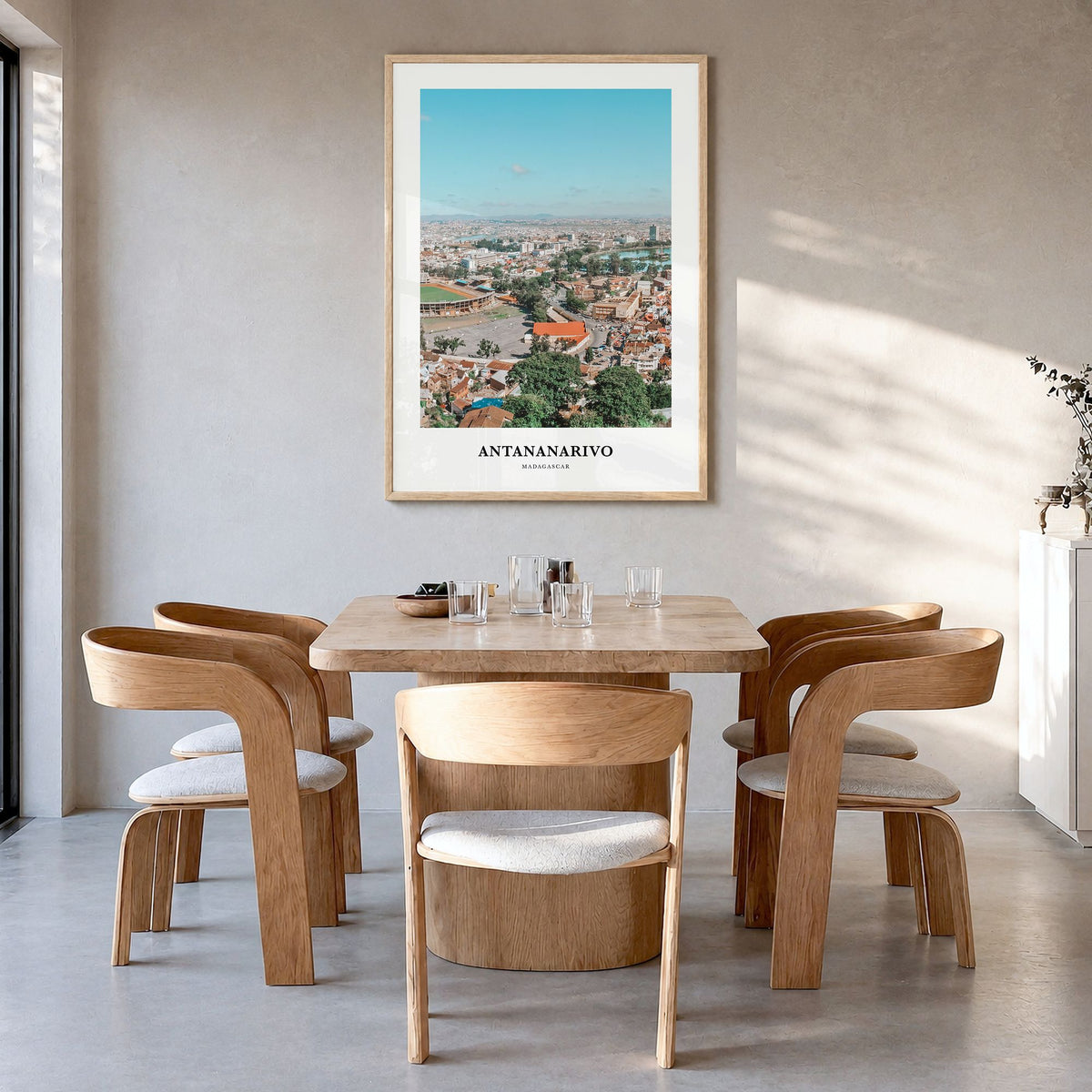 Antananarivo Classic Poster in a natural wood frame, hanging in a dining room