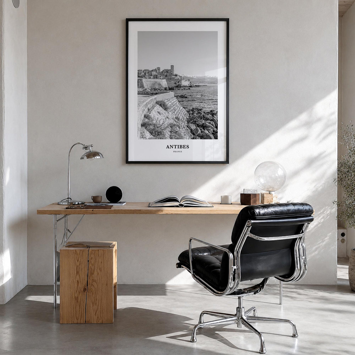 Antibes black & white classic poster of France – vertical wall art in black wood frame, hanging on wall