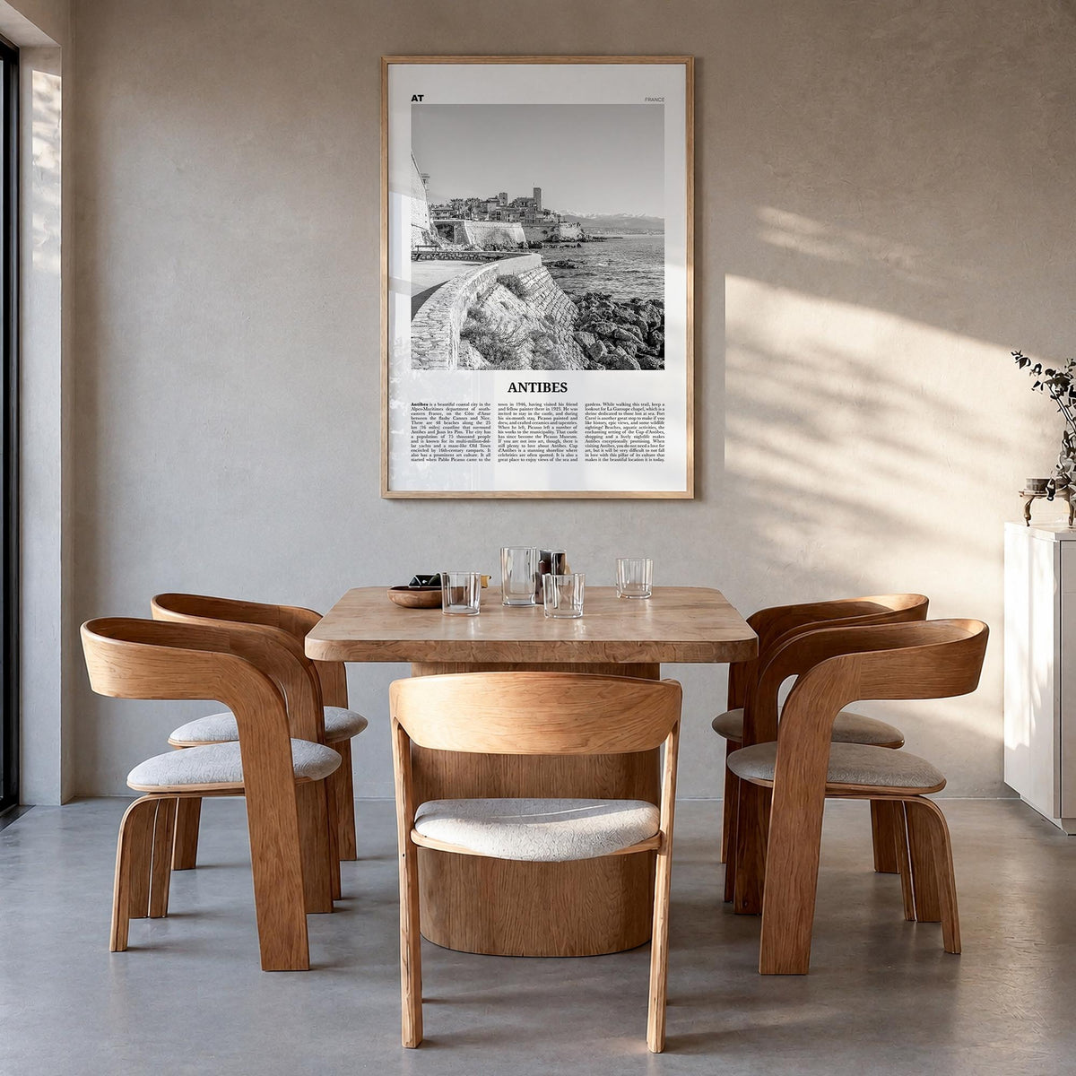 Antibes black & white newspaper poster of France – vertical wall art in natural wood frame, hanging on wall