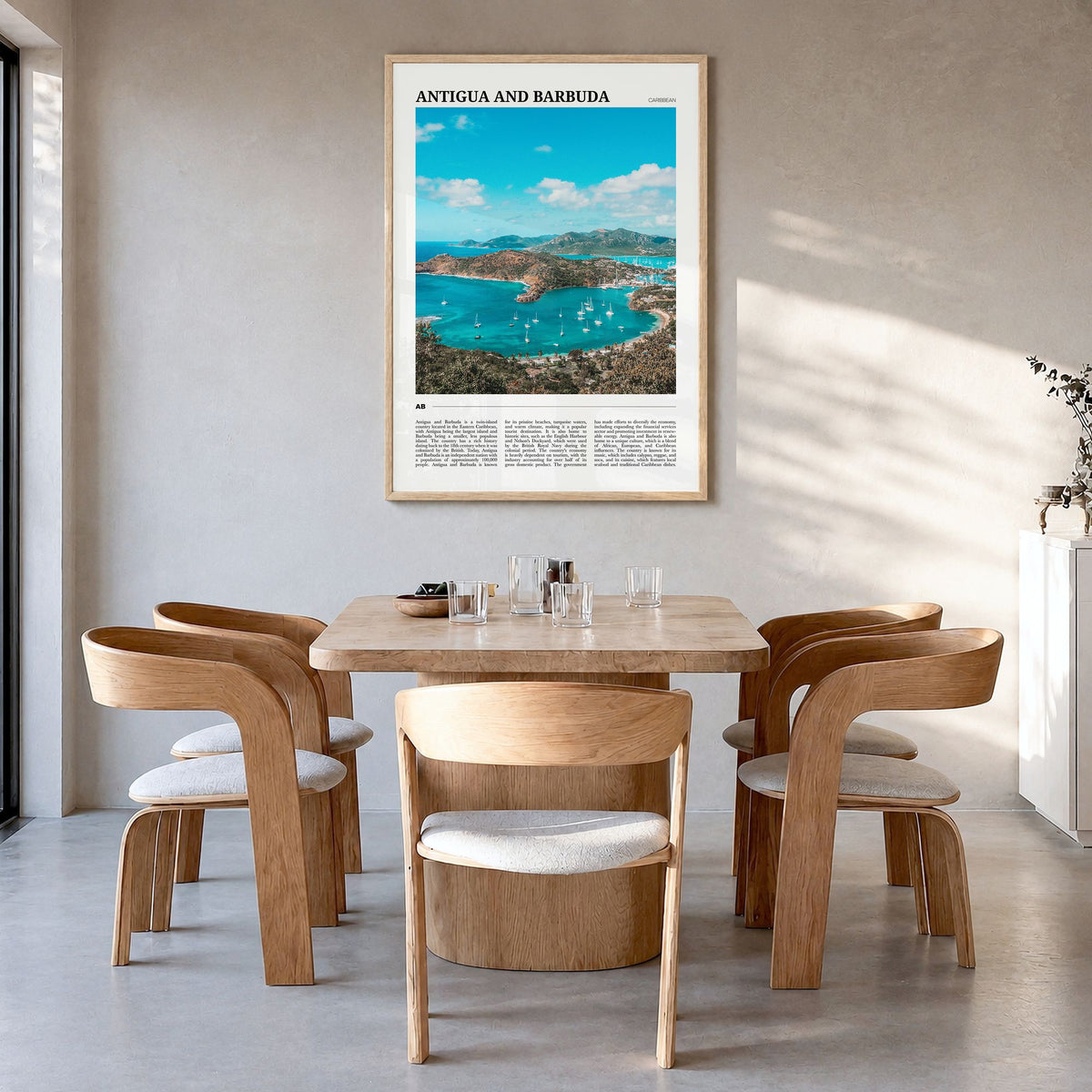 Antigua and Barbuda Travel Poster in a natural wood frame, hanging in a dining room