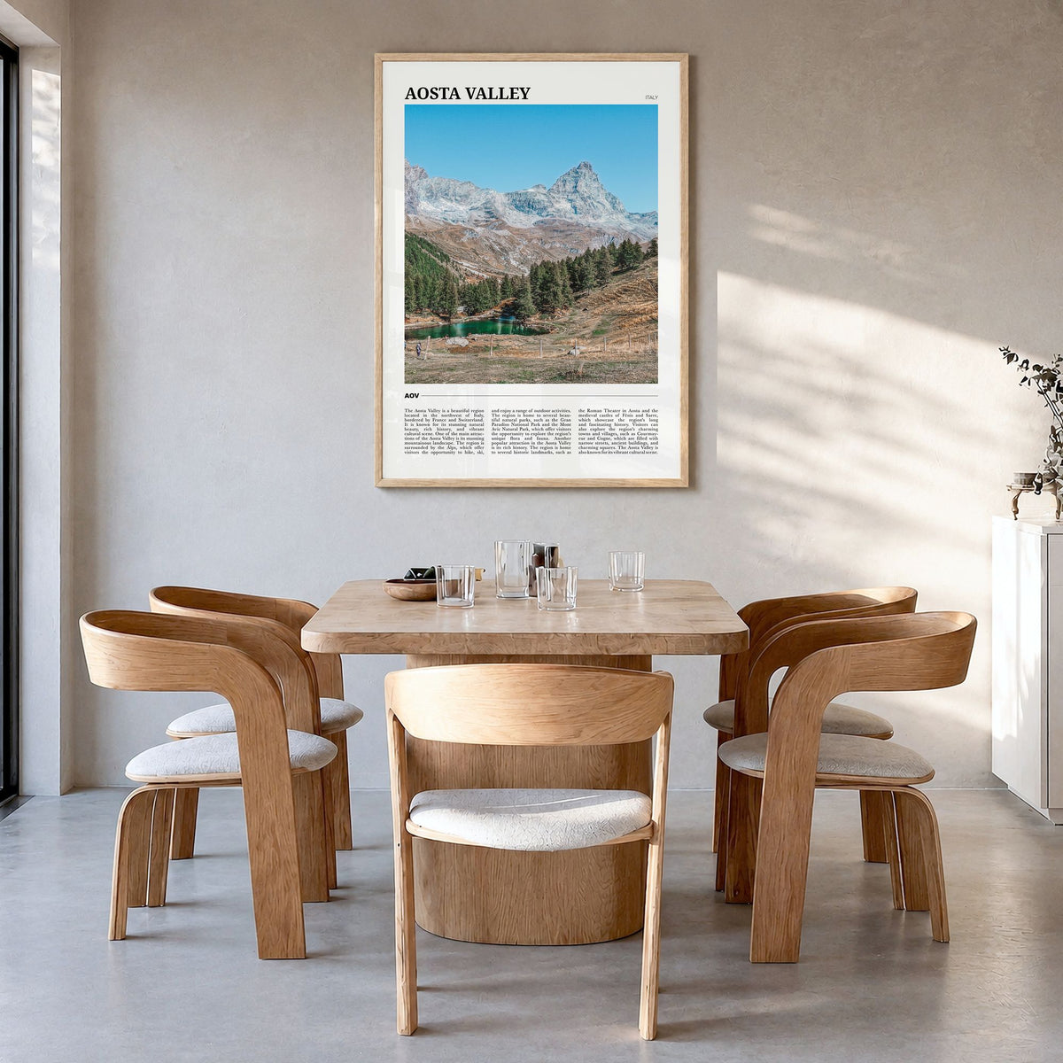 Aosta Valley Travel Poster in a natural wood frame, hanging in a dining room