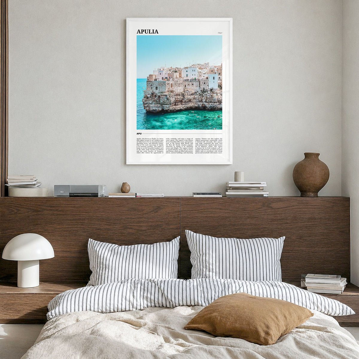Apulia Travel Poster in a white wood frame, hanging in a bedroom