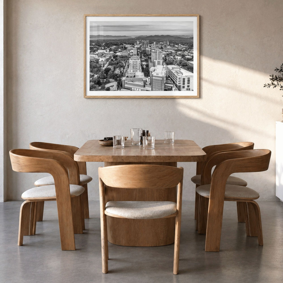 Asheville Photo Poster in a natural wood frame, hanging in a dining room, white border