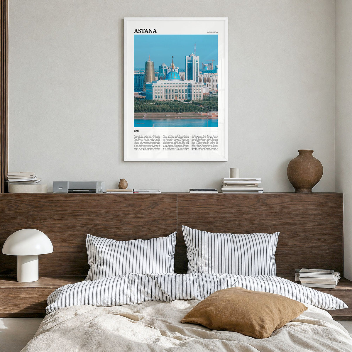 Astana Travel Poster in a white wood frame, hanging in a bedroom