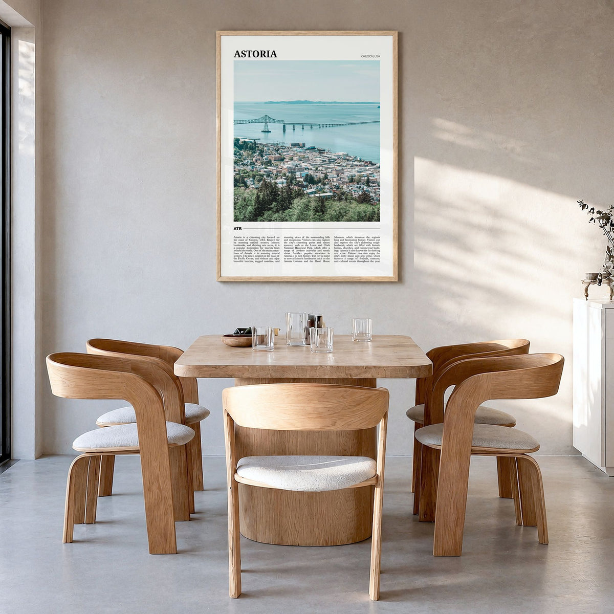Astoria, Oregon Travel Poster in a natural wood frame, hanging in a dining room
