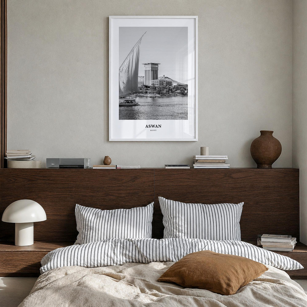 Aswan black & white classic poster of Egypt – vertical wall art in white wood frame, hanging on wall