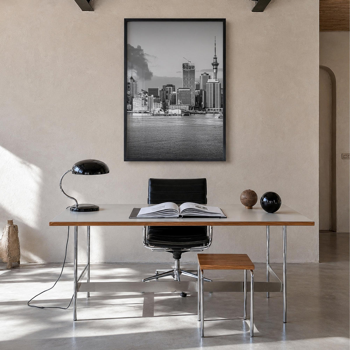 Auckland black & white photo poster of New Zealand – vertical wall art in black wood frame, hanging on wall