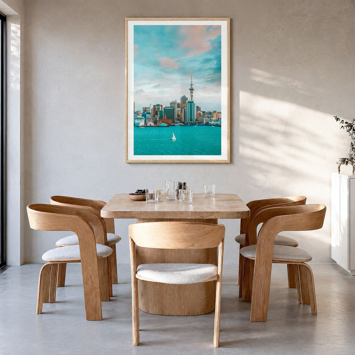 Auckland Photo Poster in a natural wood frame, hanging in a dining room, white border