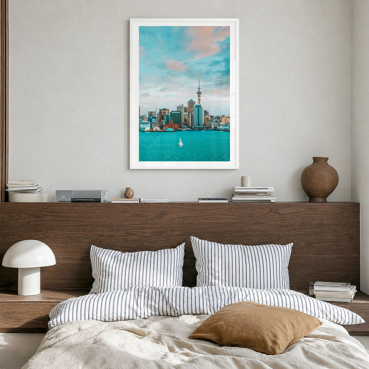 Auckland Photo Poster in a white wood frame, hanging in a bedroom, white border