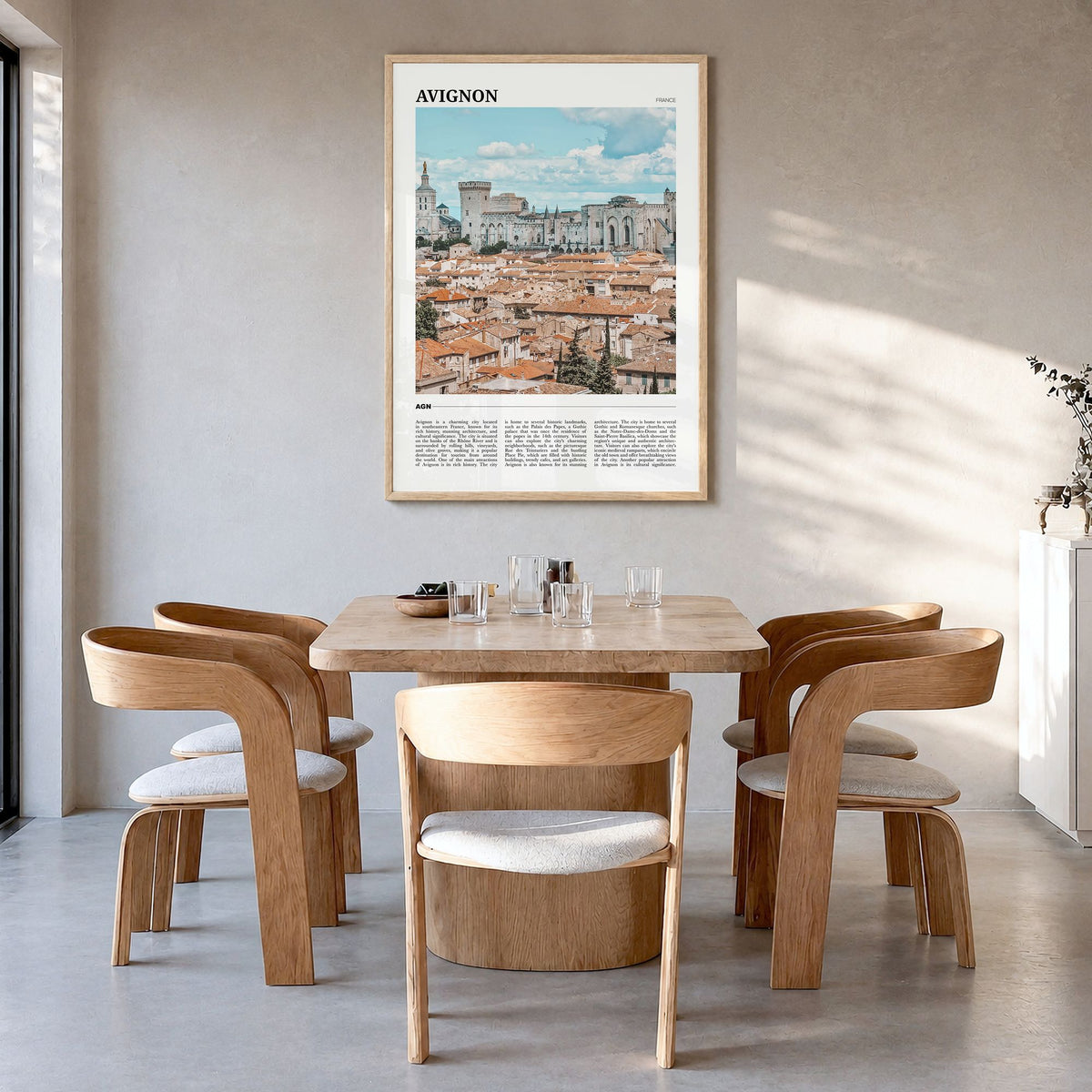 Avignon Travel Poster in a natural wood frame, hanging in a dining room