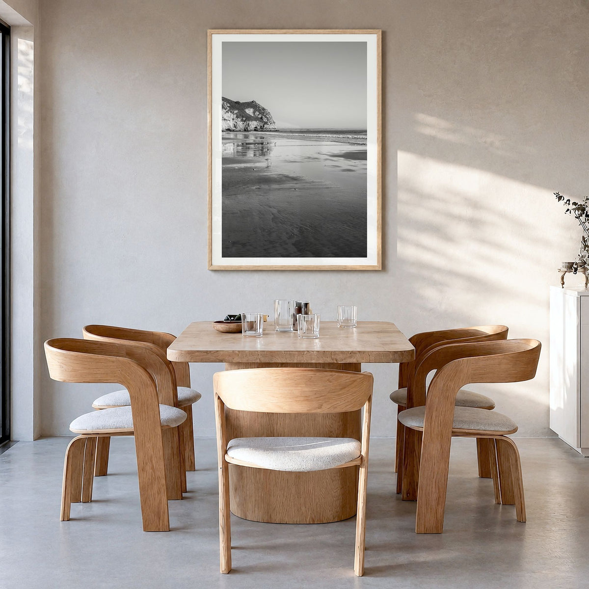 Avila Beach Photo Poster in a natural wood frame, hanging in a dining room, white border
