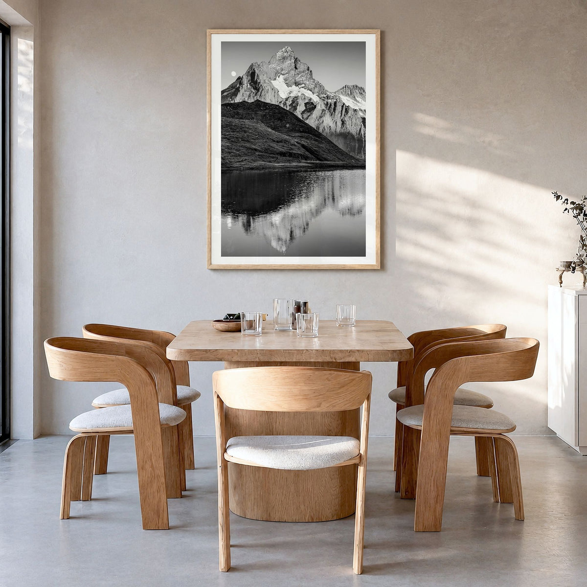 Bachalpsee Photo Poster in a natural wood frame, hanging in a dining room, white border