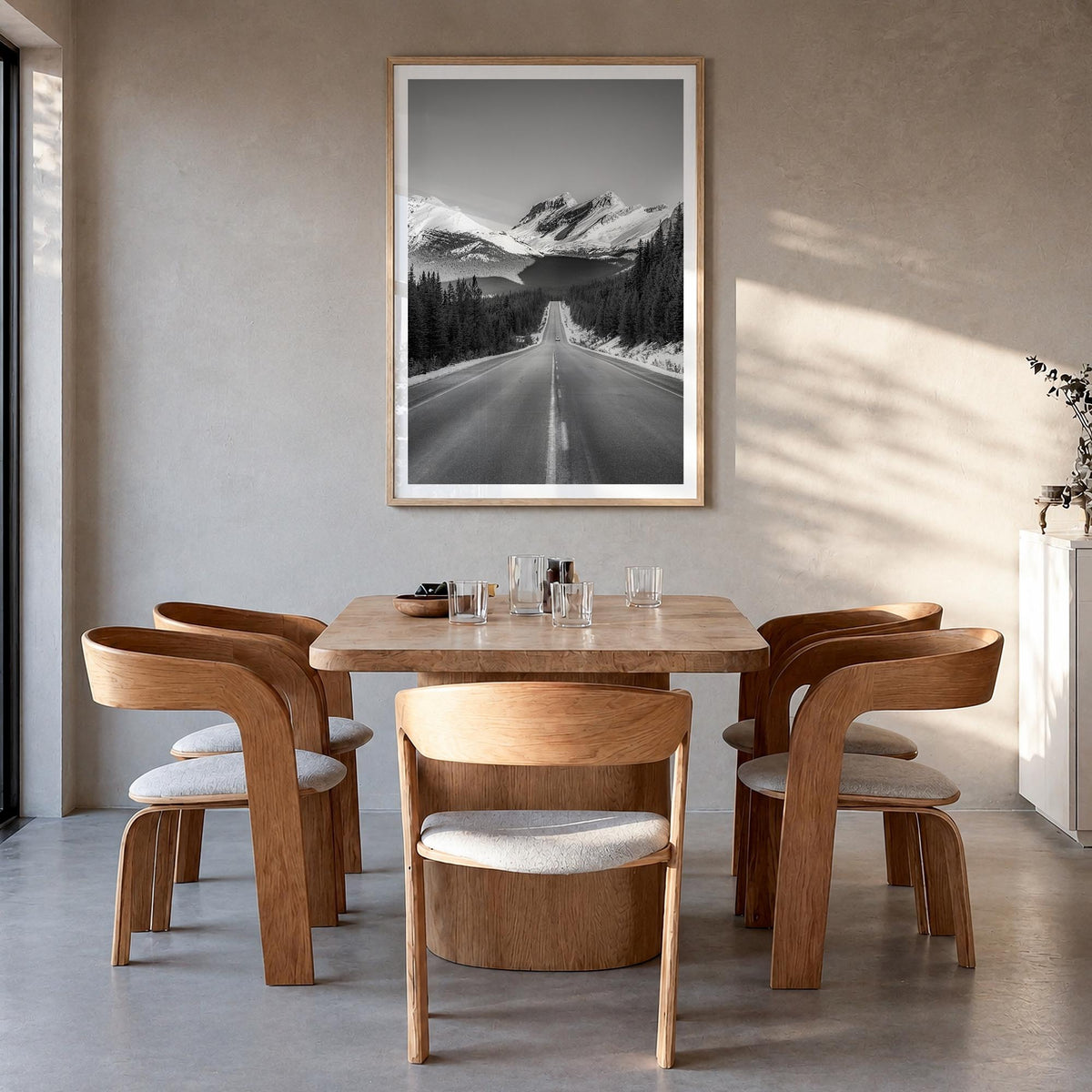 Banff black & white photo poster of Alberta, Canada – vertical wall art in natural wood frame with white border, hanging on w