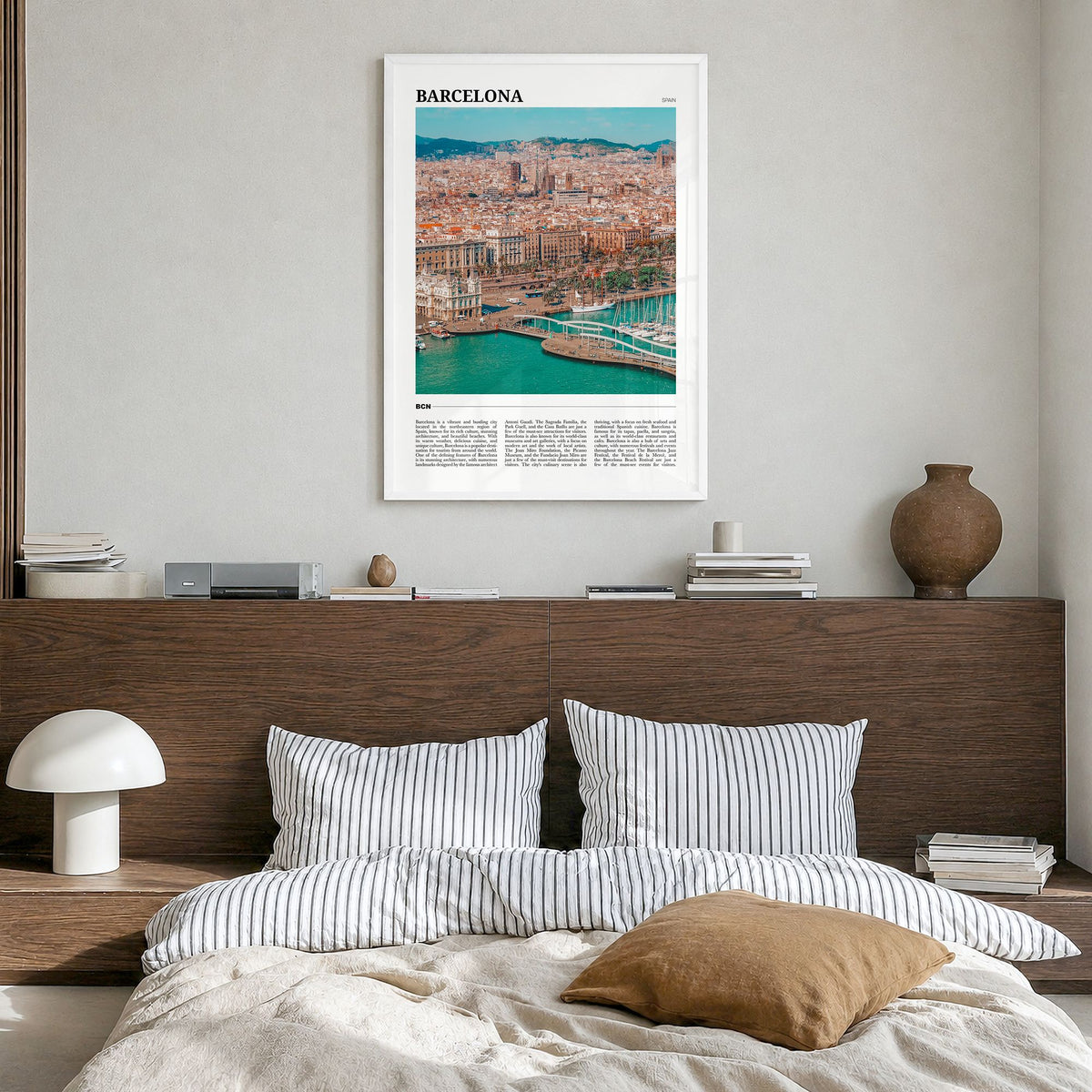Barcelona Travel Poster in a white wood frame, hanging in a bedroom