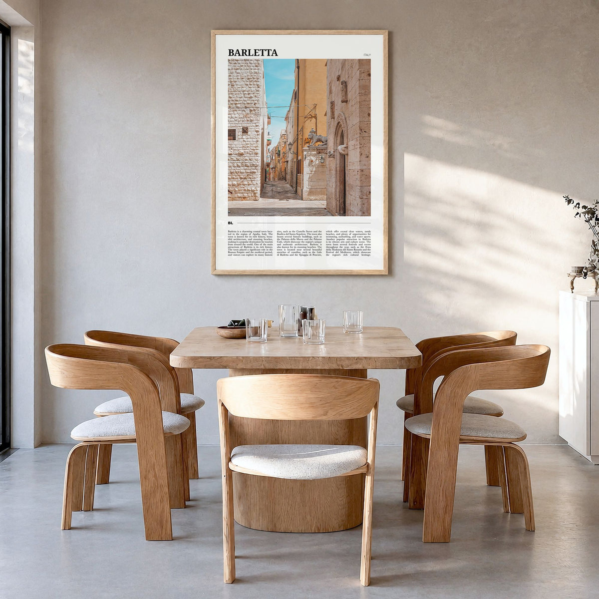 Barletta Travel Poster in a natural wood frame, hanging in a dining room