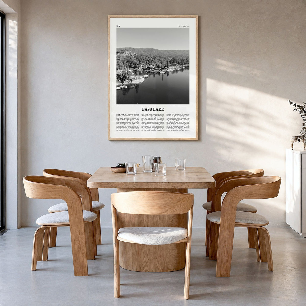 Bass Lake Newspaper Poster in a natural wood frame, hanging in a dining room