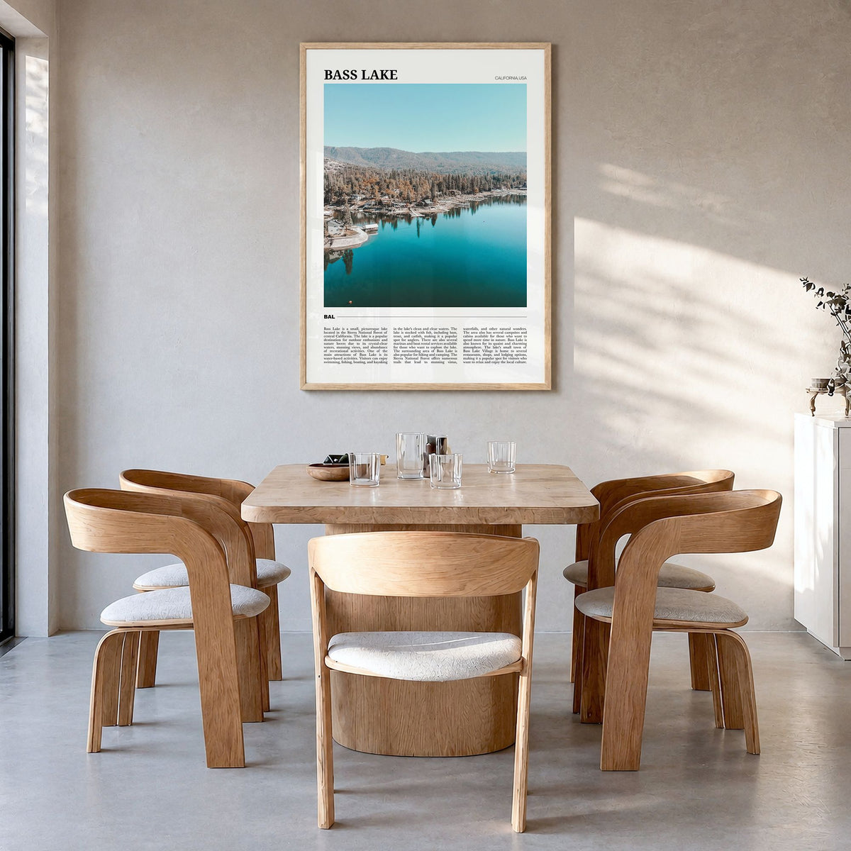 Bass Lake Travel Poster in a natural wood frame, hanging in a dining room
