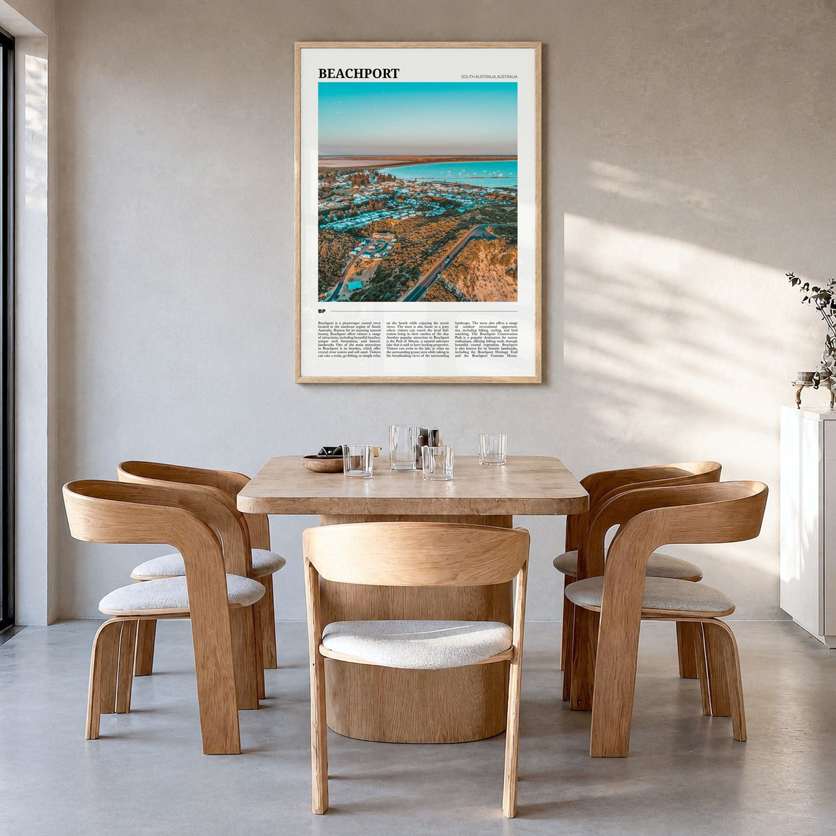 Beachport Travel Poster in a natural wood frame, hanging in a dining room
