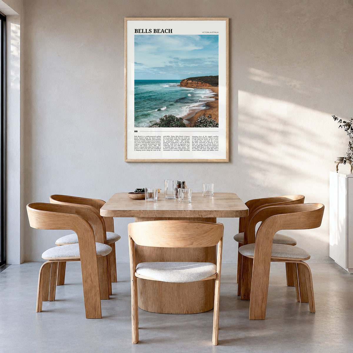 Bells Beach Travel Poster in a natural wood frame, hanging in a dining room