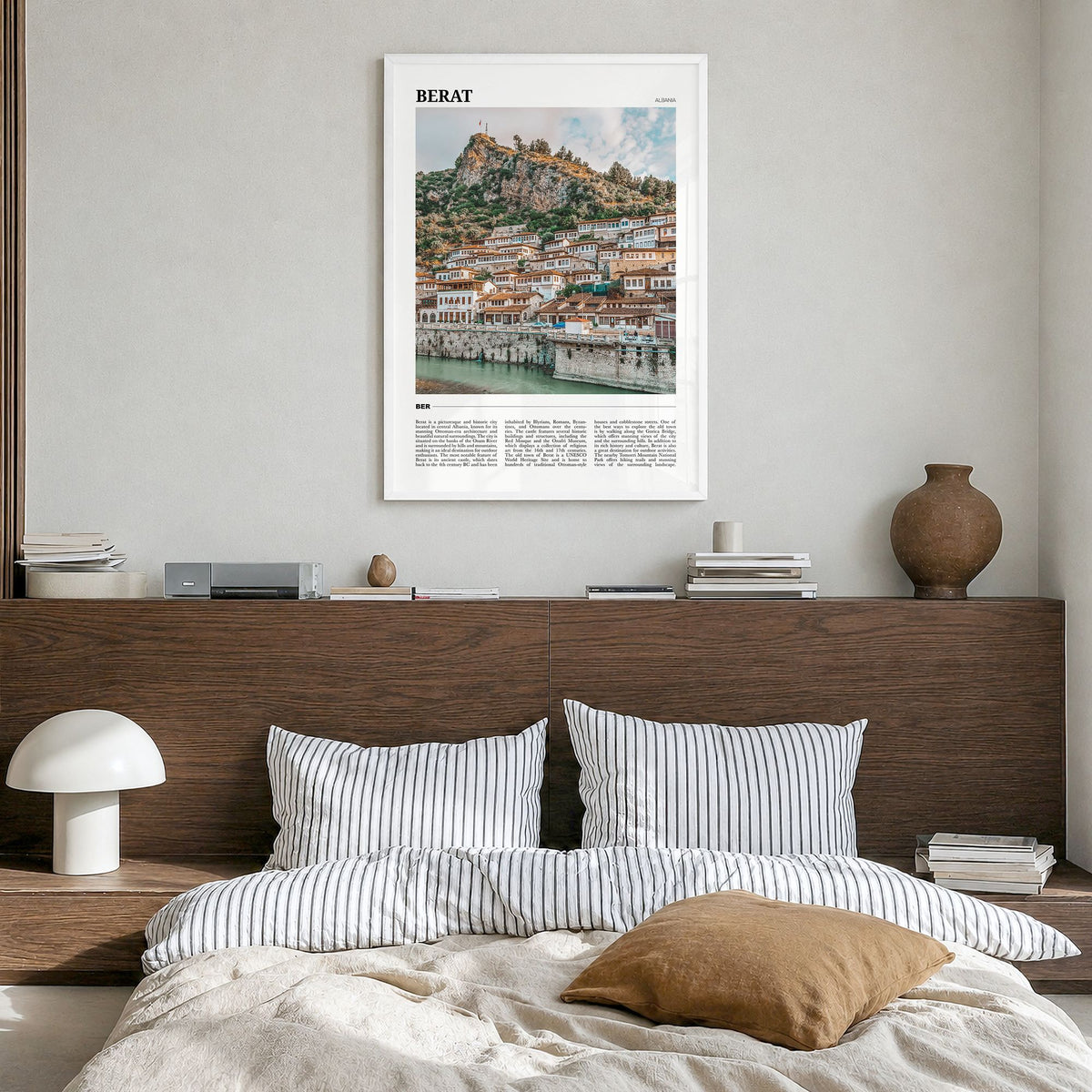 Berat Travel Poster in a white wood frame, hanging in a bedroom