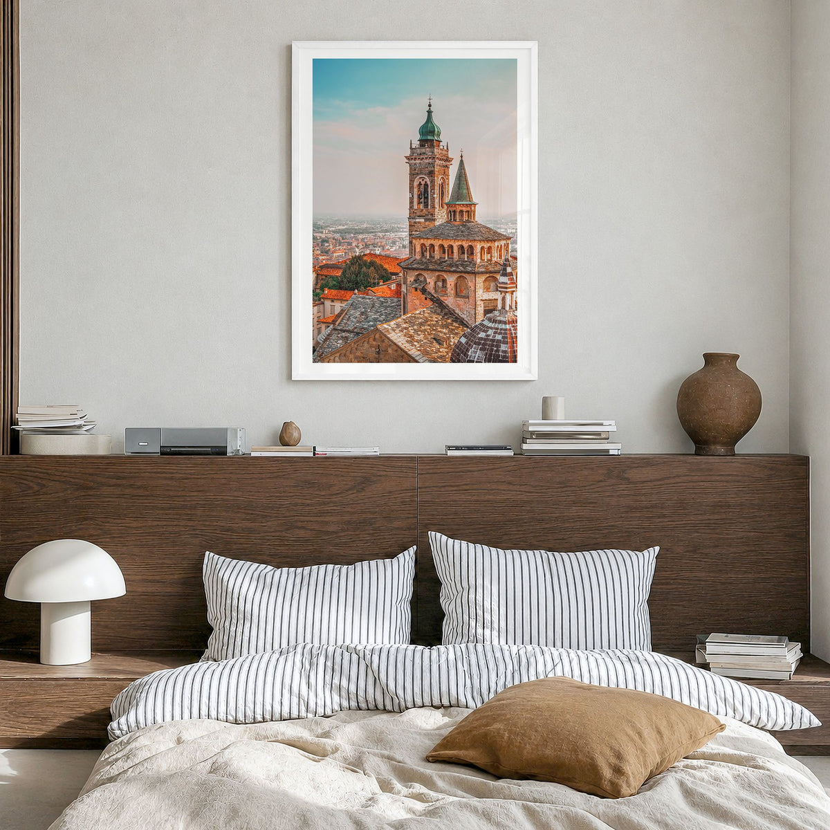 Bergamo Photo Poster in a white wood frame, hanging in a bedroom, white border