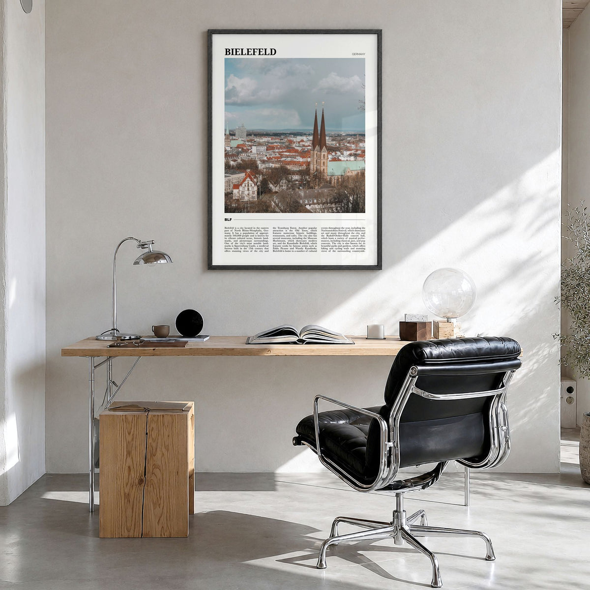 Bielefeld Travel Poster in a black wood frame, hanging in a bright home office