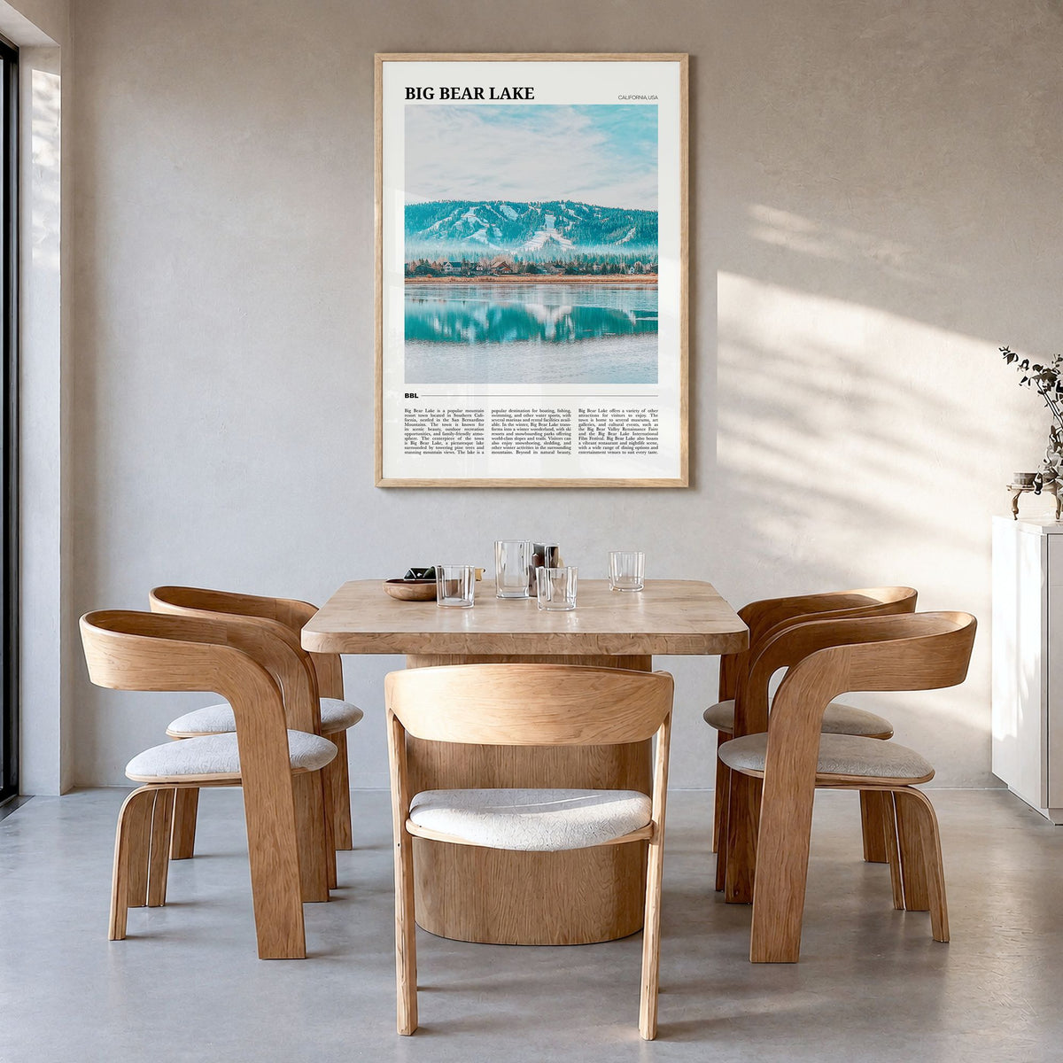 Big Bear Lake Travel Poster in a natural wood frame, hanging in a dining room