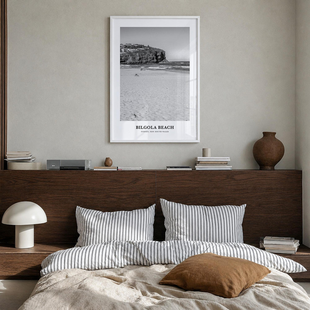 Bilgola Beach black & white classic poster of Australia – vertical wall art in white wood frame, hanging on wall