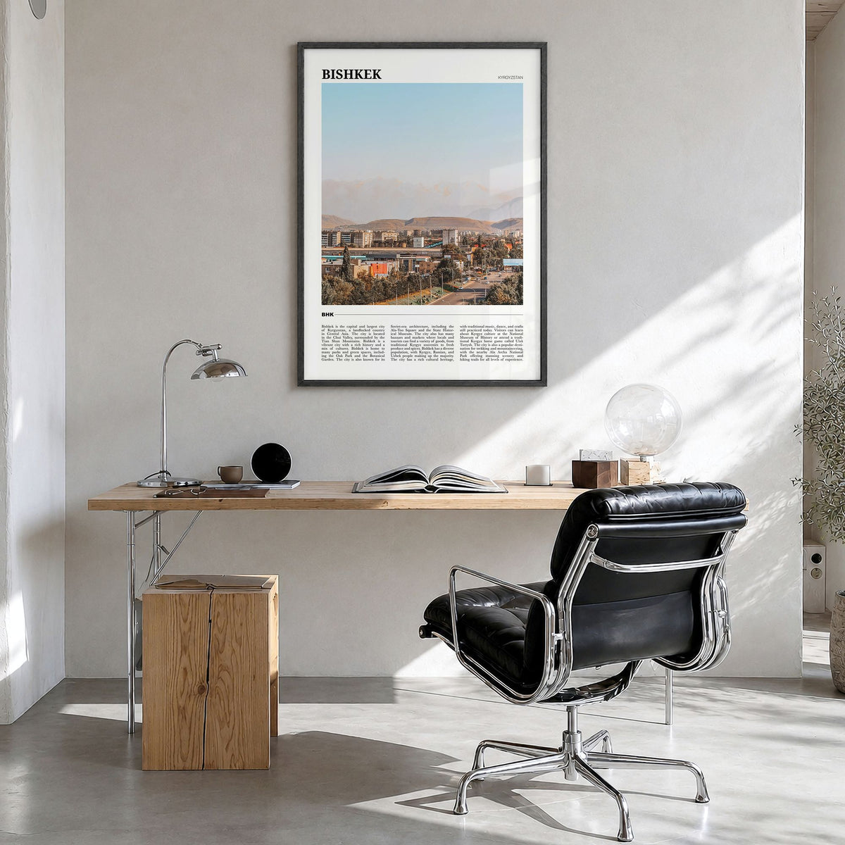 Bishkek Travel Poster in a black wood frame, hanging in a bright home office