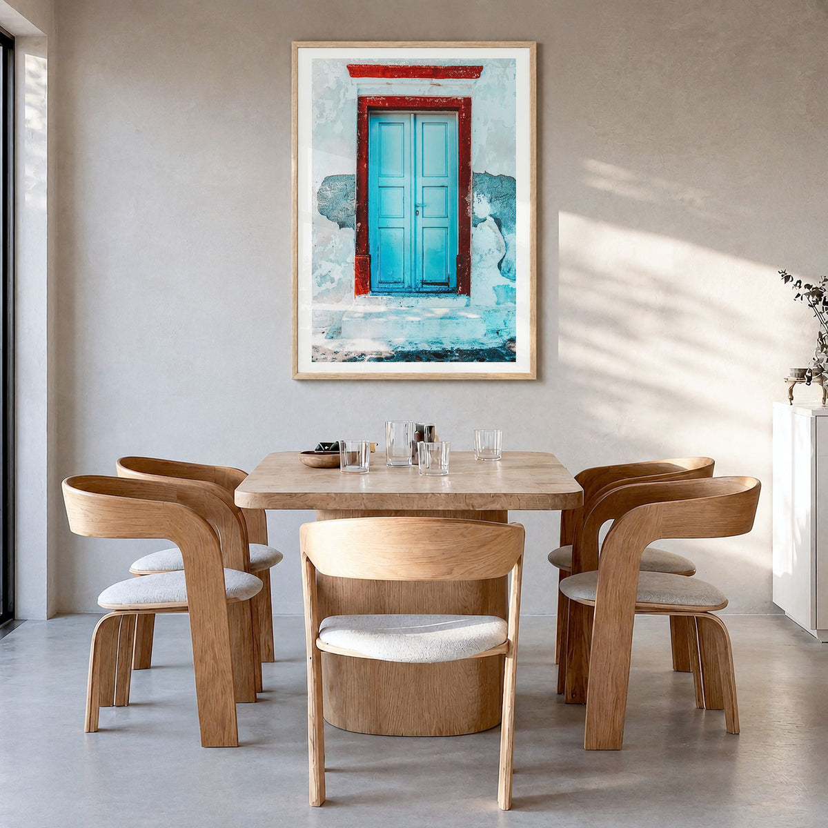 Blue Door Photo No 2 Poster in a natural wood frame, hanging in a dining room, white border