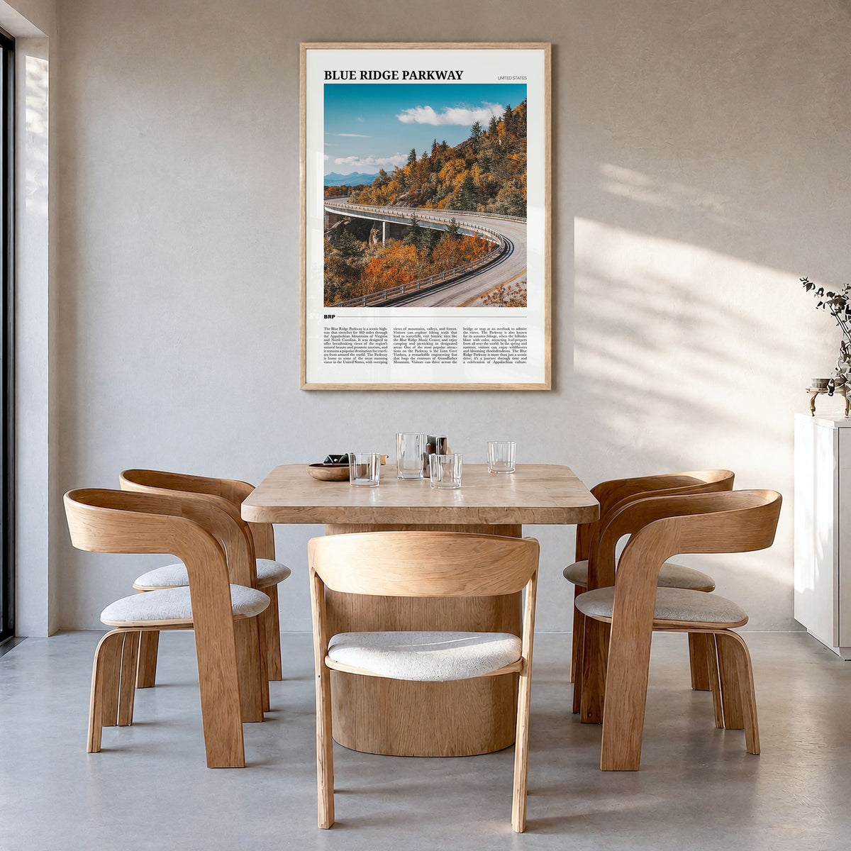 Blue Ridge Parkway Travel Poster in a natural wood frame, hanging in a dining room